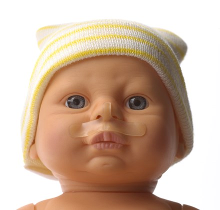 Face of baby doll wearing NEO-prep Neonatal CPAP Skin Barrier